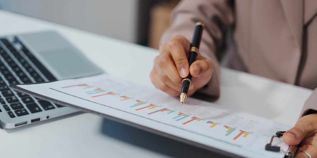 An Asian businesswoman accountant calculates invoices, taxes, interest, loans using a calculator,working online to guide clients through financial planning ensure a smooth loan process for success